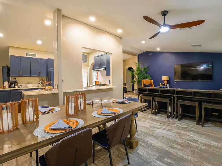 Open plan living room, dining room, kitchen, entry way.
Living room has 2 leather couches with queen size hide away bed, dining table seats 10, sliding door to patio seating