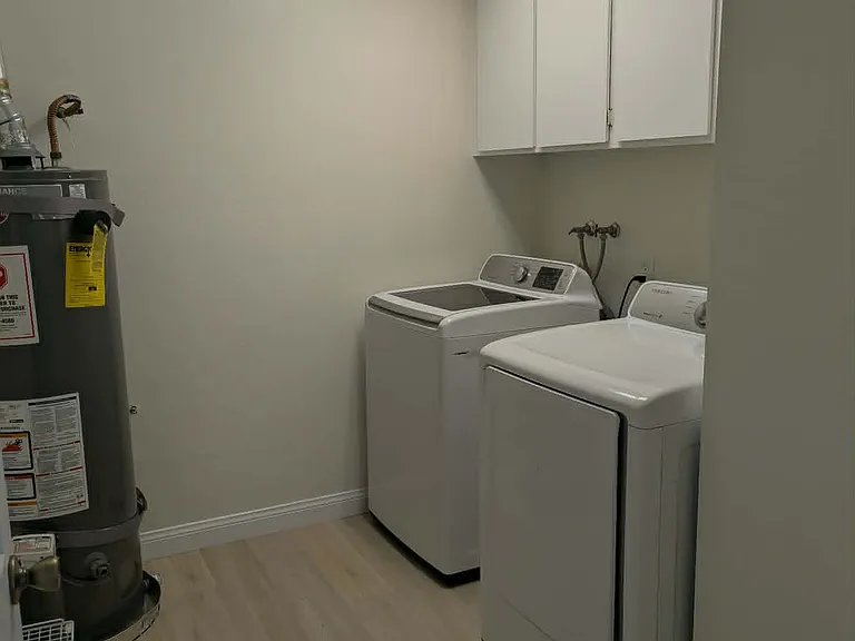 Large laundry room with storage off hallway