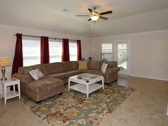 From the entry the diagonally laid tile leads you into the spacious family room.