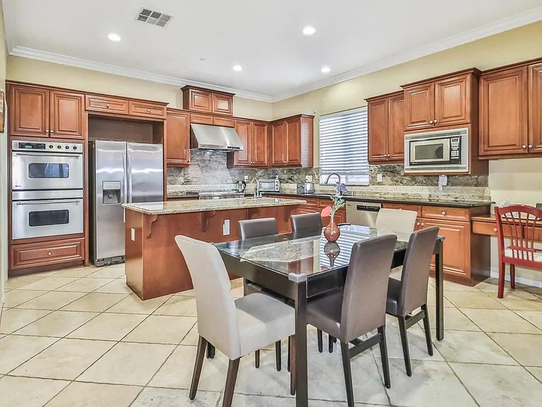 Large Kitchen with island, breakfast area, work desk and open to family room.