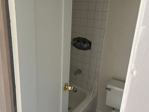 Bathroom with tub to the right of entering the unit