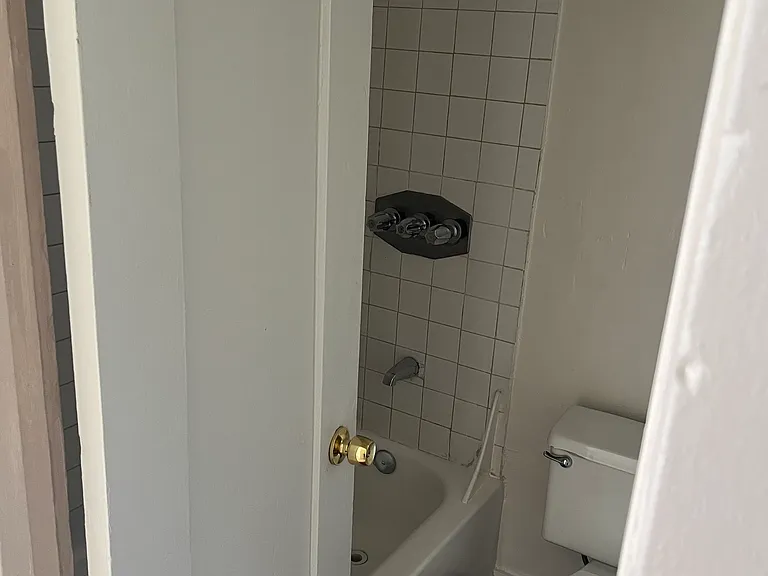 Bathroom with tub to the right of entering the unit