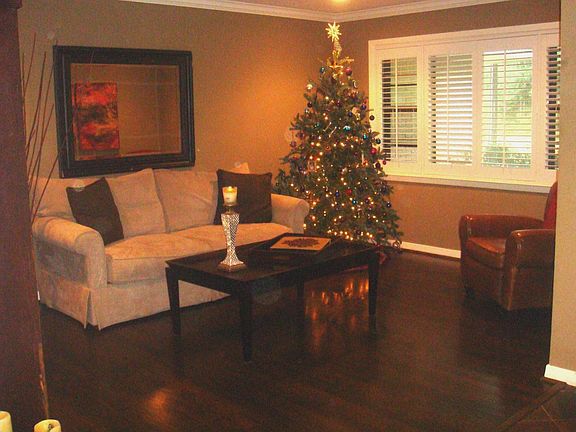 Front room has plantation shutters and hardwood floors