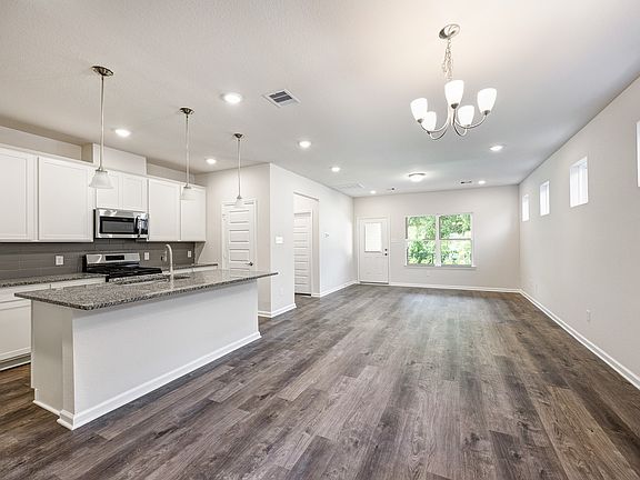 The Robin II- Dining Area into Family Room and Kitchen