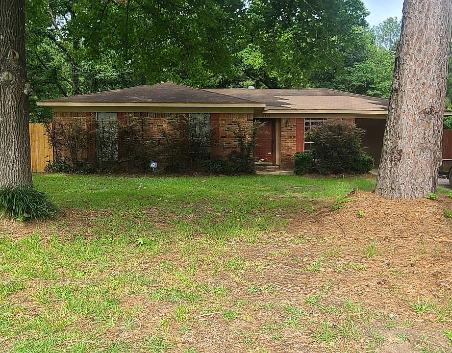 Front of house with large shade trees