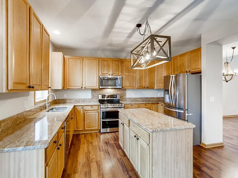Kitchen with granite countertops and stainless steel appliances.