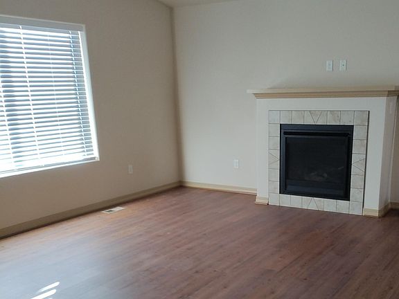 Wood look plank flooring in living room. Gas log fireplace.