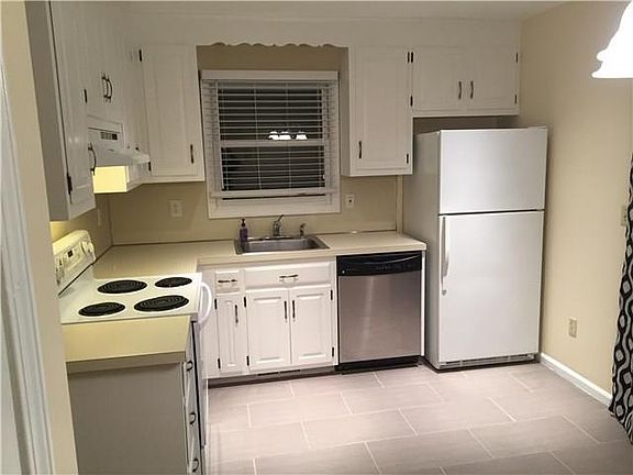 Kitchen with oven, dishwasher & fridge