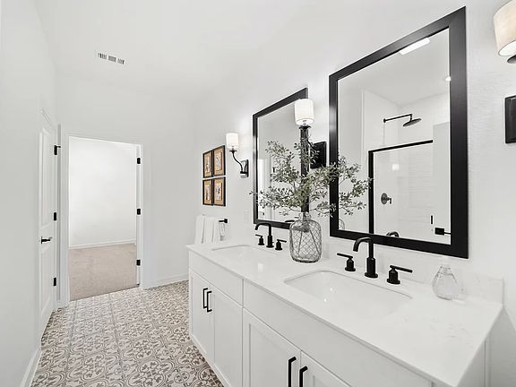 Primary bath features freestanding vanity with dual sinks