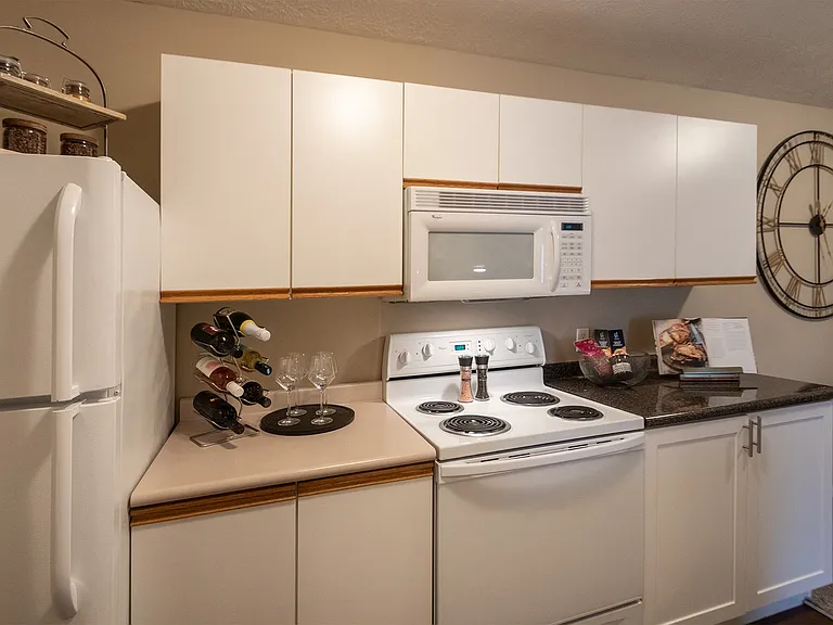Our model Liberty kitchen features both upgraded cabinetry with dark countertops and classic cabinetry with light countertops.
