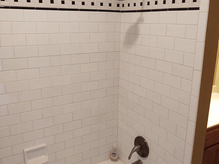 Upstairs Cast Iron/Tile Tub/Shower in Second Full Bathroom. Tile Floor.