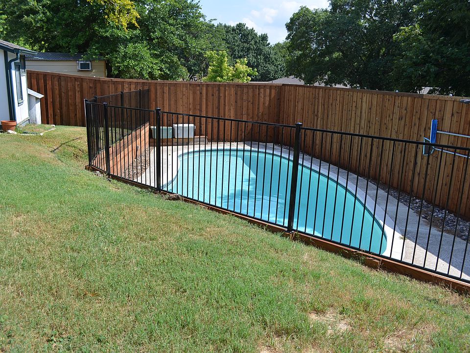 pool with recently replaced 6ft wood fence, retainer wall & iron fence