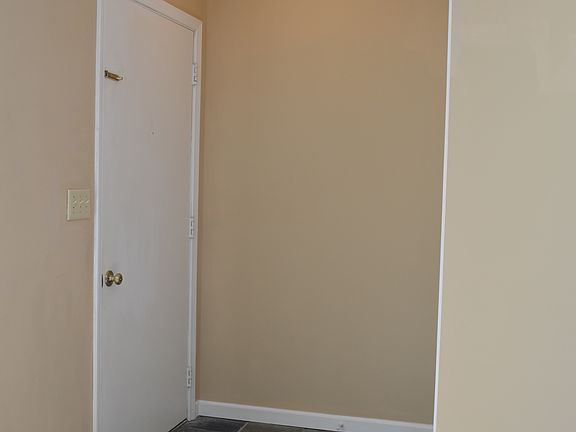 Entrance with slate floor and coat closet