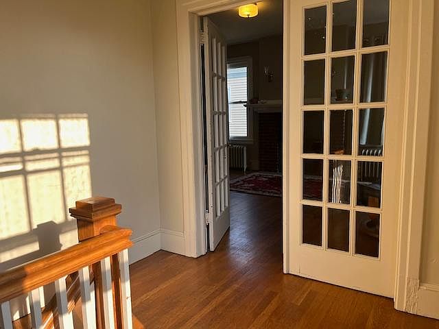 Private front staircase leading to french doors to the living room