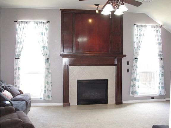 Imagine relaxing next to this fireplace during the winter time!  The tall windows provide a breathtaking view of the over-sized back yard.