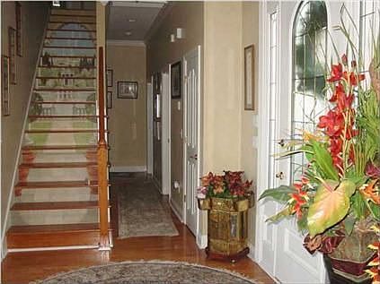 An elegant foyer with a custom staircase welcomes you into this fine home