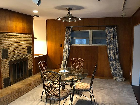 Fireplace and second living area opens to covered patio with mosaic mural.