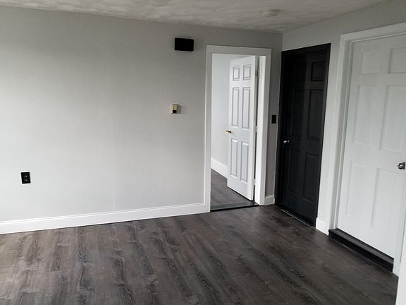 Living room looking at front door and master bedroom door