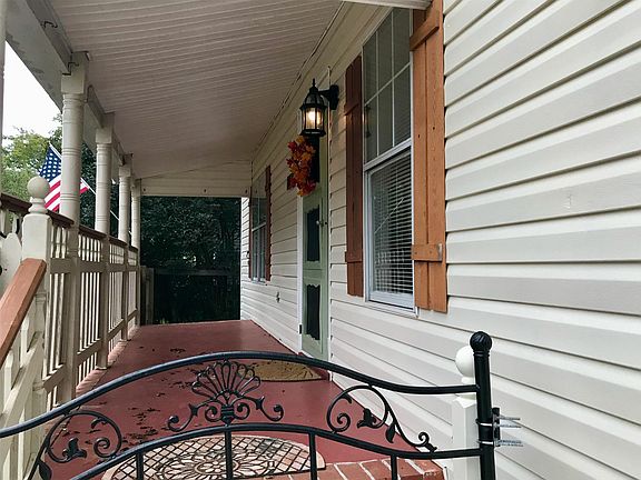Whimsical, inviting covered front porch