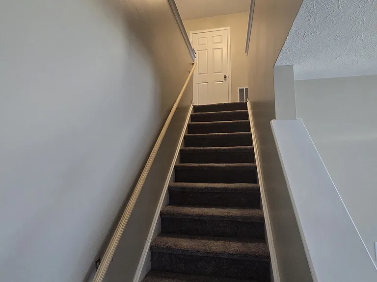 Staircase with utility room at the top