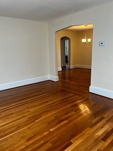 Living room hardwoods and 4 windows.
