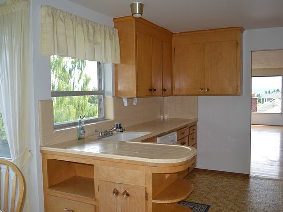 Bright kitchen with tile counter tops. Views to Mount Baker and Mount Rainier.