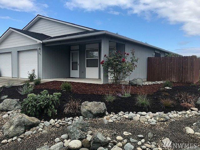 Welcome to the covered porch with no step entry and new landscaping with irrigation system, maintained by HOA