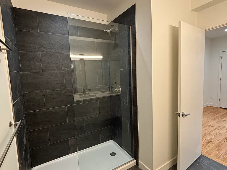 Stand-up shower in primary bedroom with heated floors