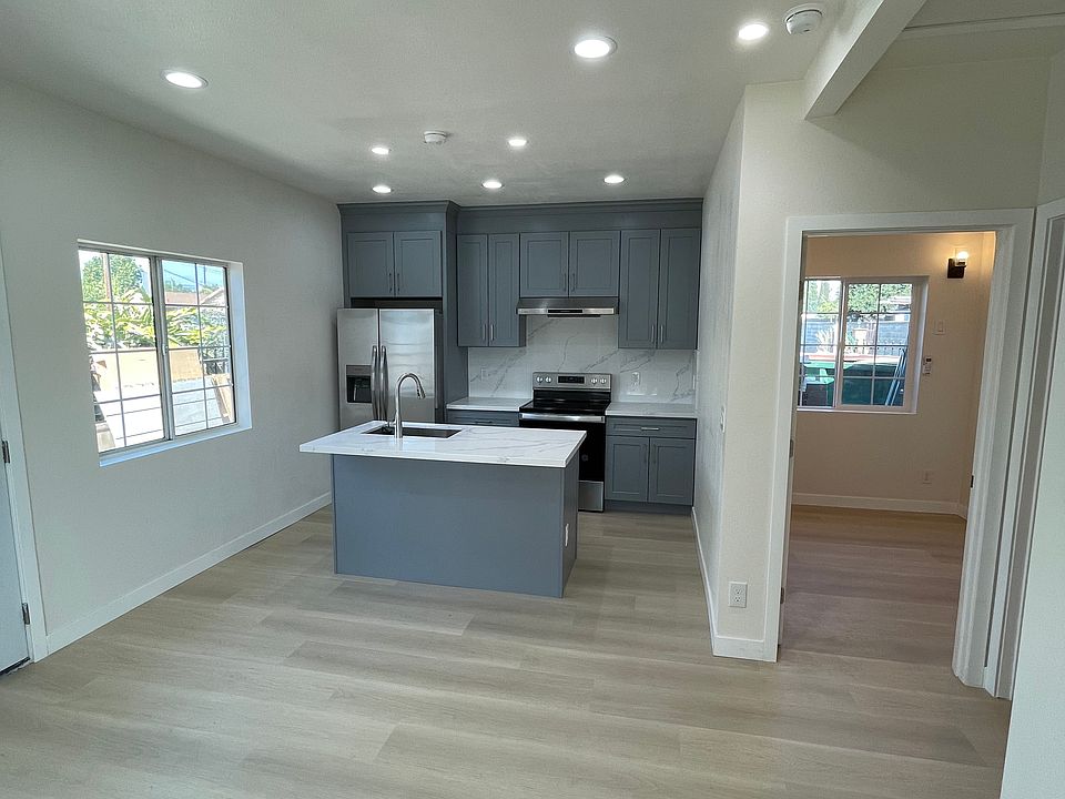 Living room + Kitchen 
Entrance to Office on the right