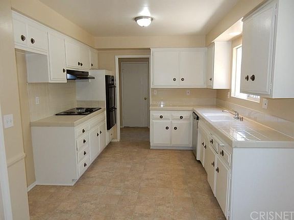 Kitchen with new appliances, light fixture and linoleum. Great work space.