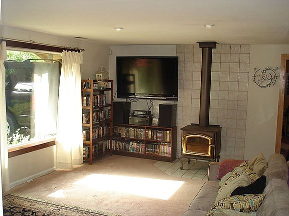 Family room with large picture window and woodstove
