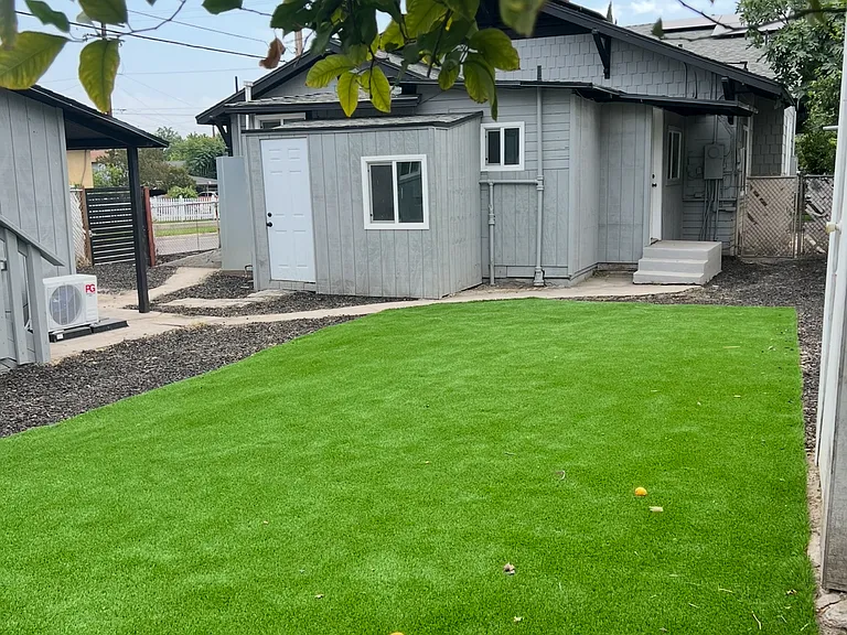 Backyard space with artificial turf to Enjoy