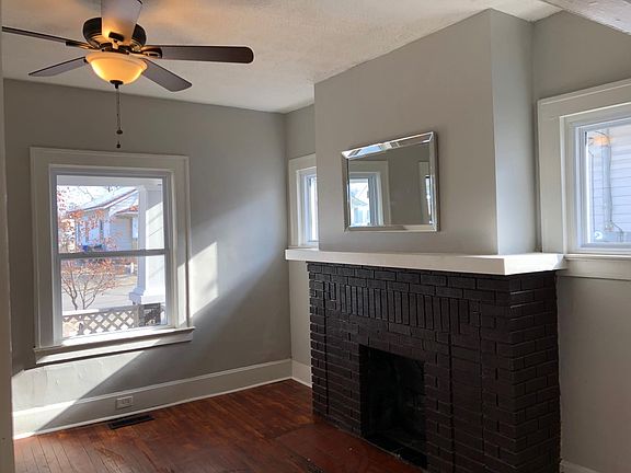 Very cozy living room with non-functional fireplace, behind