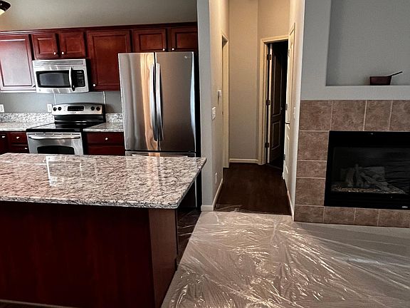Down the hallway to the guest bath, pantry and second bedroom ( brand new carpet is covered with temporary plastic cover )