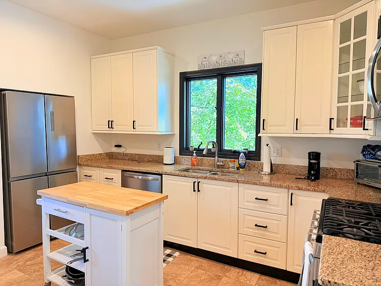 kiitchen with updated appliances and center island (on wheels).