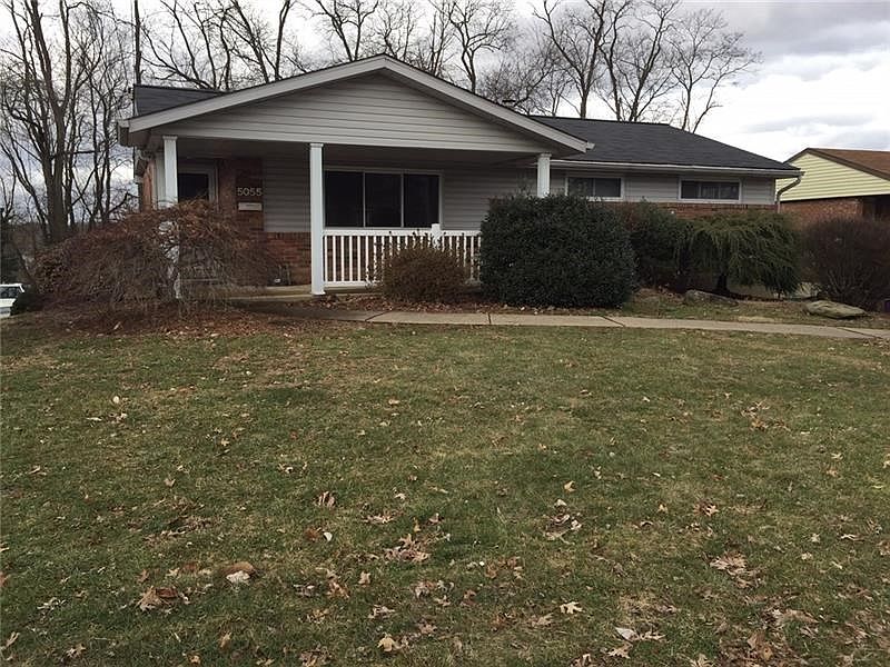 Relax and enjoy the view sitting on this lovely covered front porch