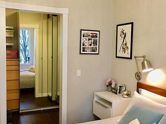 Spacious walk-in closet with build-in organization unit with mirror doors