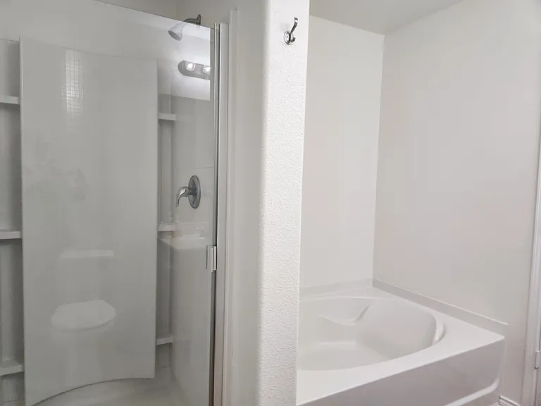 Primary bedroom has separate tub and shower