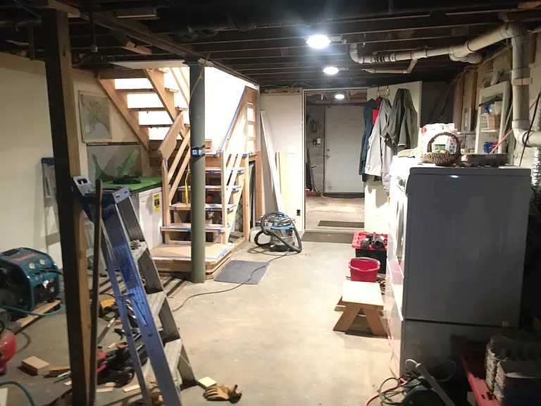 Very large utility room and second storage room 12'x14' in daylight basement of home. Stairs in photos connect to main hallway upstairs.