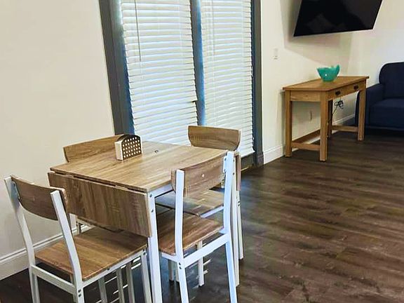 Inviting living space with Smart TV, coffee table, and natural light.
