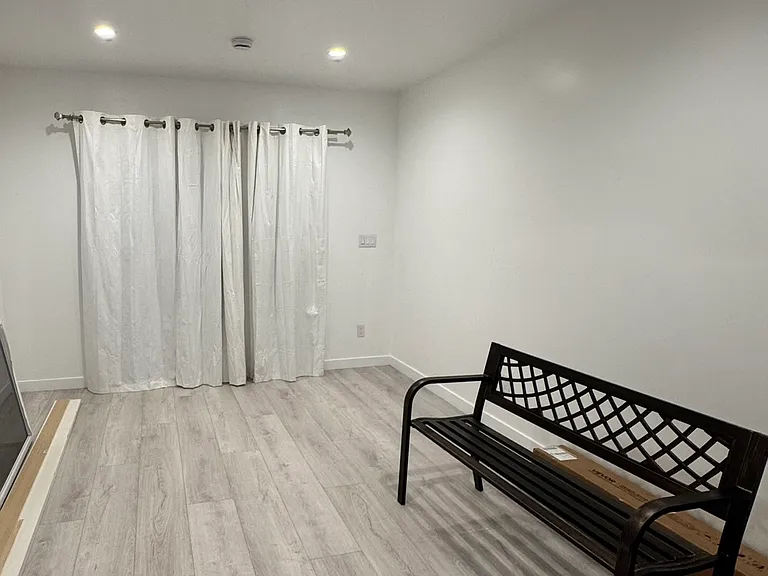 Spacious living room with elevated wall outlet for large TV and entertaining and sliding door to private backyard.