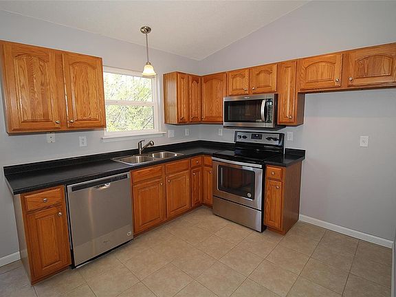 Brand new stainless steel Whirlpool appliances including dish washer, electric range and microwave as well as new countertop, stainless steel sink and faucet and hardware for the cabinets.