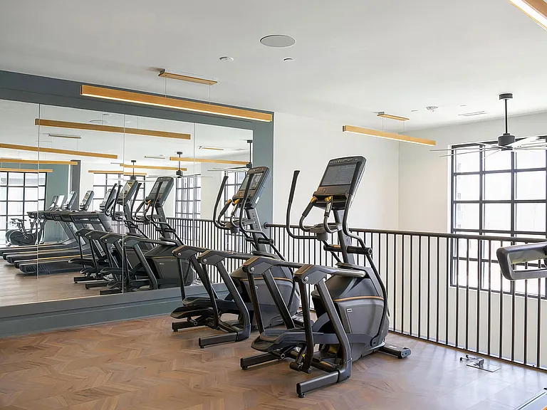 Second-story cardio area with modern elliptical machines