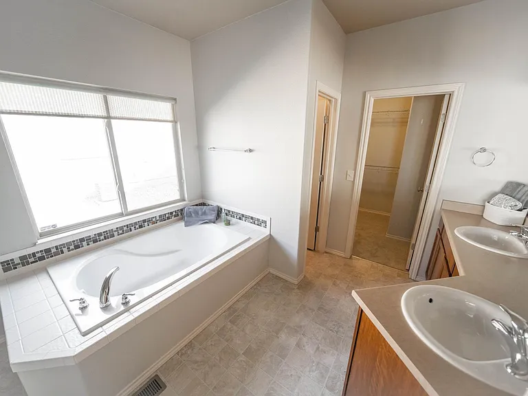 Master bath with master closet as right door and toilet as left