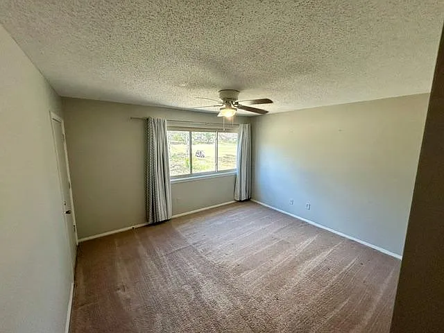 Oversized Primary Bedroom with door to balcony and large window view of Golf Course.