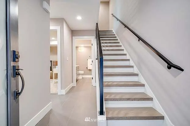 Lower level has its own entrance, two bedrooms, a spa-like full bath, walk-in closet, and balcony.