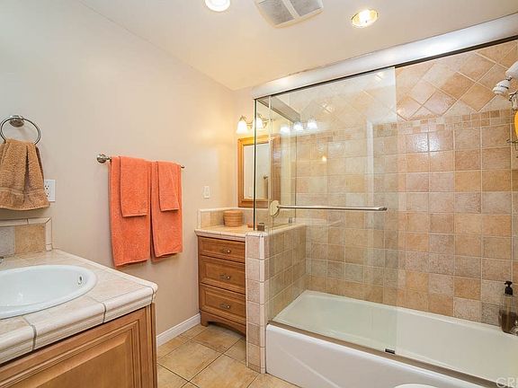 Remodeled full bathroom with tiled shower over tub