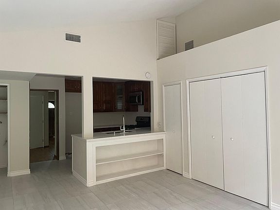 Den and adjoining kitchen