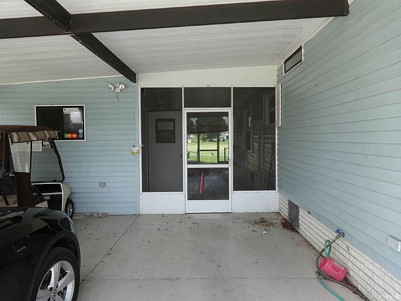 Carport leading to screened in area