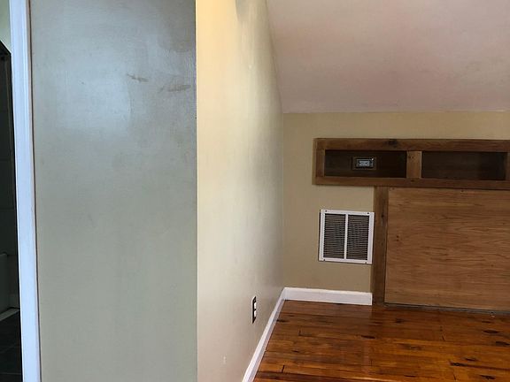 Bedroom with built in lighting and shelf with power